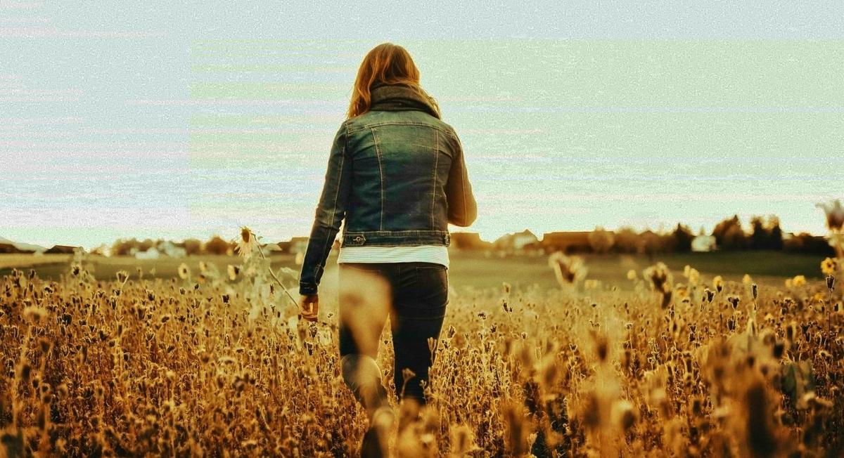 Woman walks out of field
