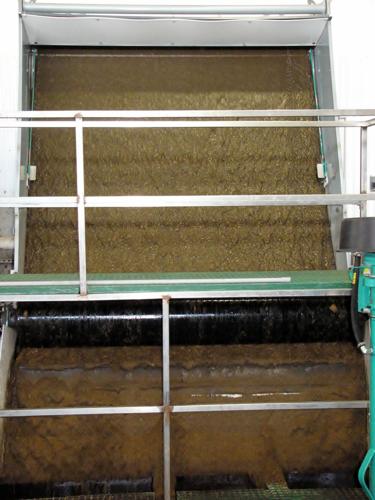 Slope screen separates solids