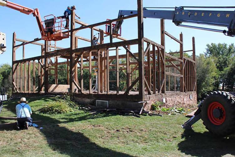 Amish crew dismantles the barn