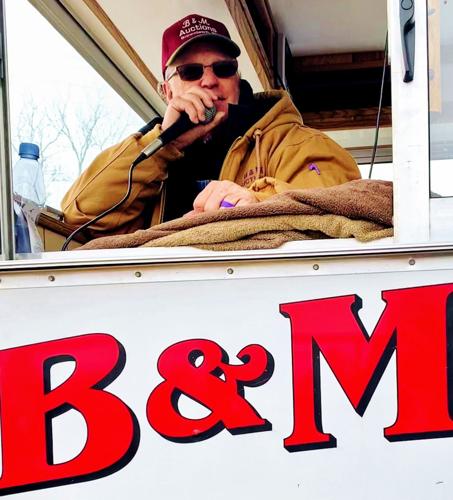 Tom Bidlingmaier in auctioneer trailer