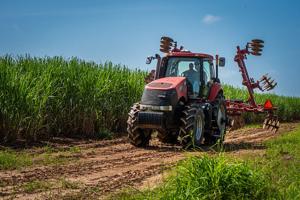 Eddie driving tractor with daughter