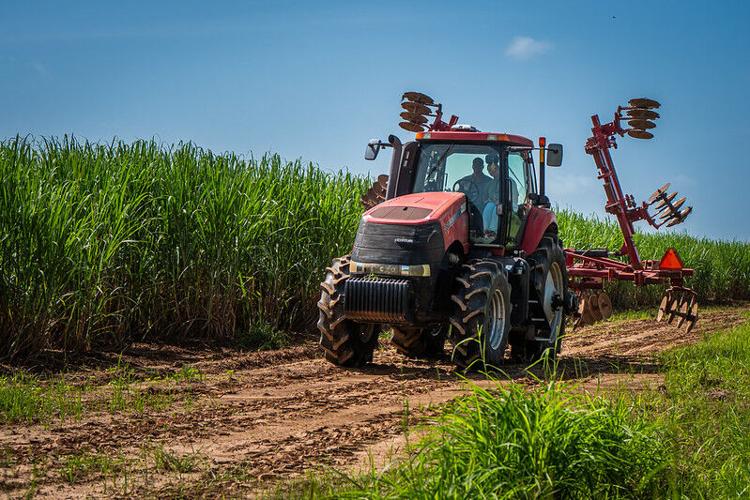Eddie driving tractor with daughter