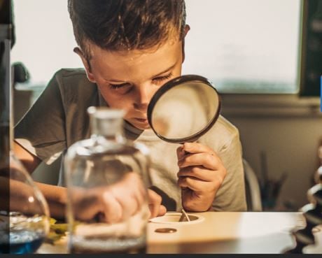 Child with magnifying glass