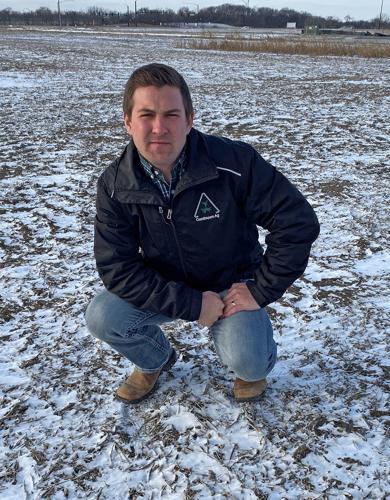Mitchell Hora stands in a snowy field.