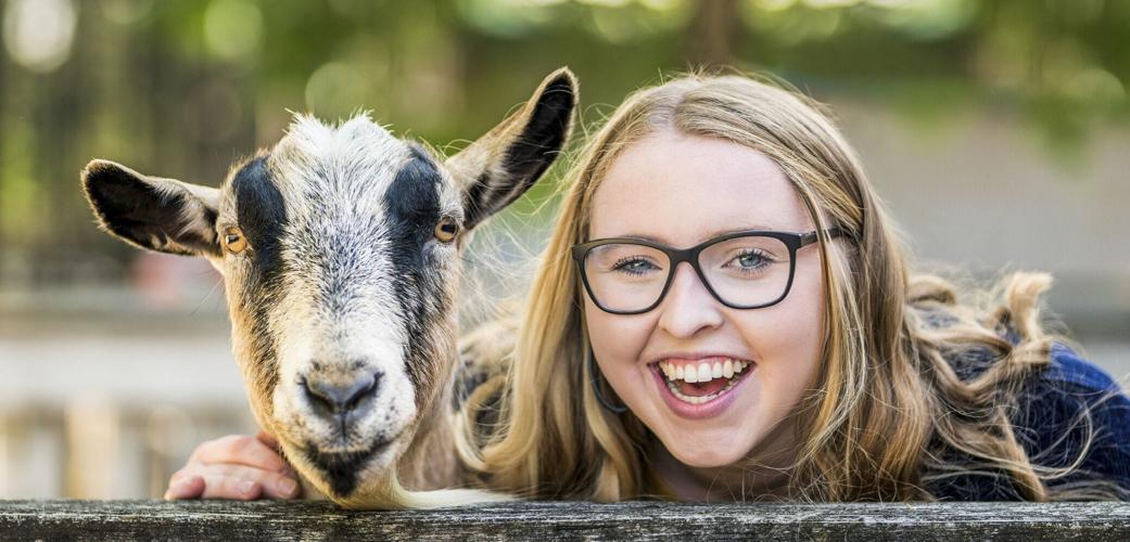 Sophie Koehler is photobombed by the Irvine Park goat.