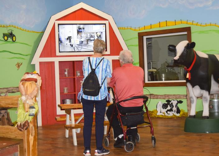 Couple watching video of milking robot