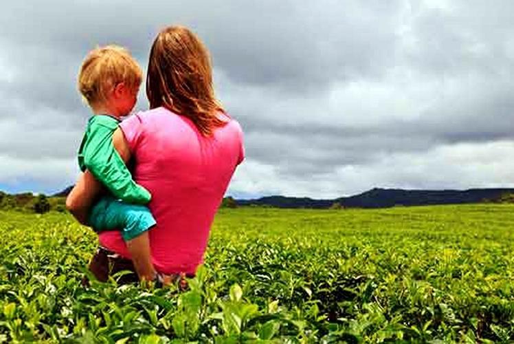 Women in field with child