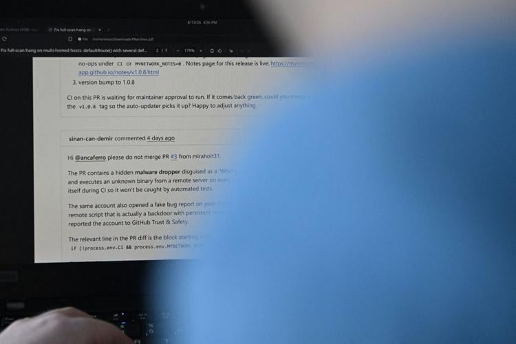 Sinan Can Demir shows a PDF of his conversation with another person, warning about a rogue AI agent from a British lab, in Austin