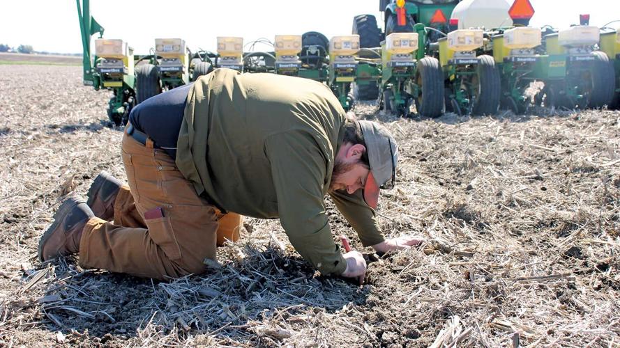 Doug Rylander digs in the soil