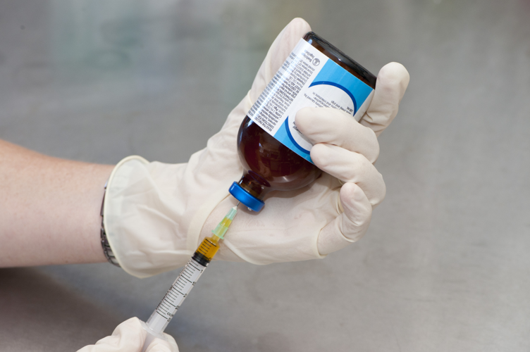Hands with needle and bottle