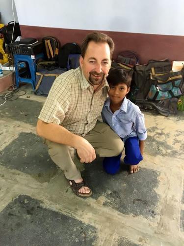 Tom Gardner and orphan in India