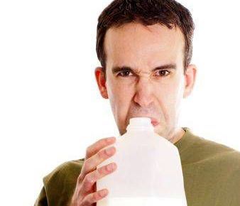 Man smelling sour milk