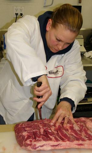 Marie Benzschawel cuts steaks