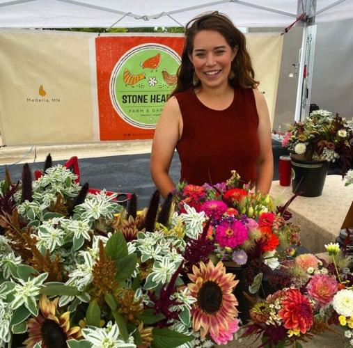 Caitlyn Wiederhoeft sells flowers at a farmers market.