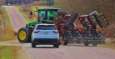 Tractor making left-hand turn and motorist in passing lane