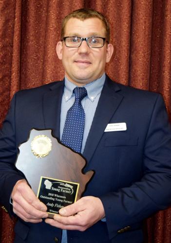 Andy Fisher with Wisconsin Outstanding Young Farmer plaque