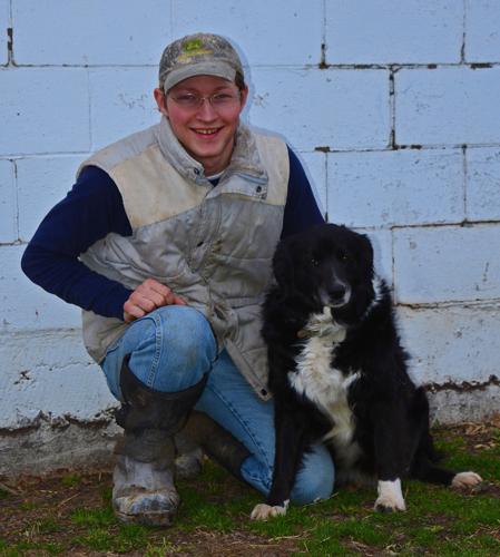 Matt Wundrow sits in front of his family's dairy barn