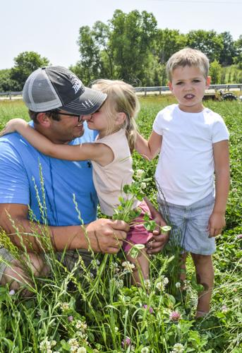 Claire Clary,3, gives her dad, Austin Clary, a kiss as Barron Clary, 5, waits his turn.