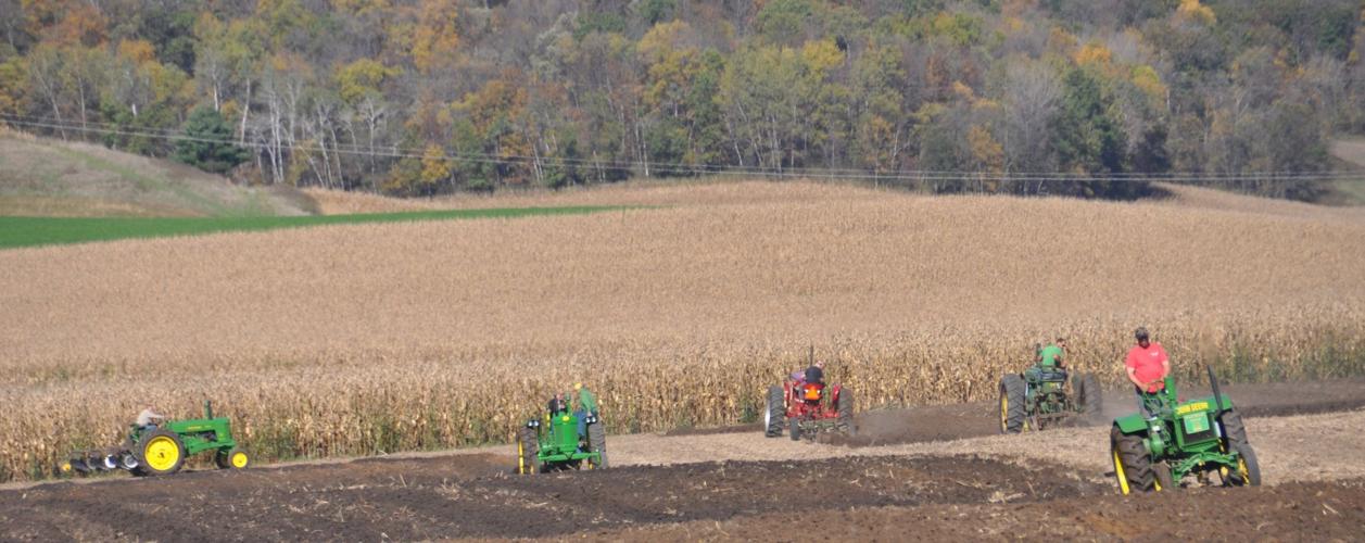 Tractors plowing