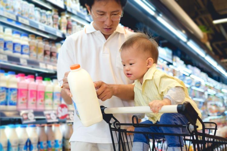 Parent and child choose milk at store