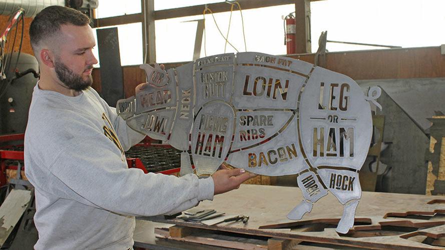 metal art pieces that shows pork cuts