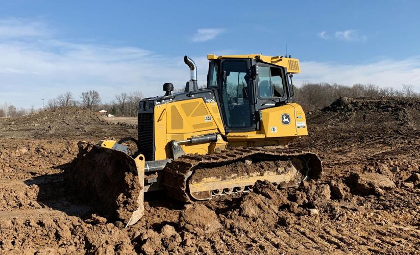 Bulldozer excavating for pond scrapes