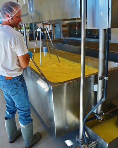 Ron Henningfeld stirs a batch of cheese
