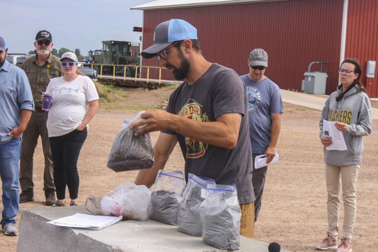 Tenzin Botsford shows different stages of compost
