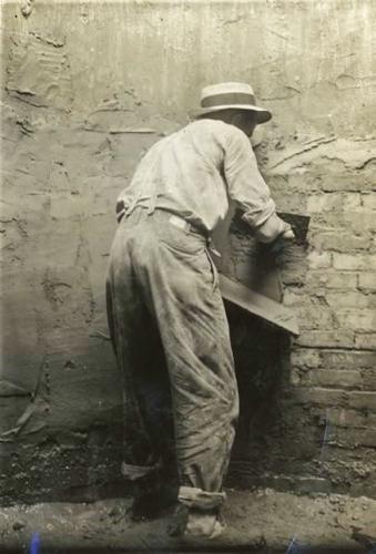 Man spreads cement