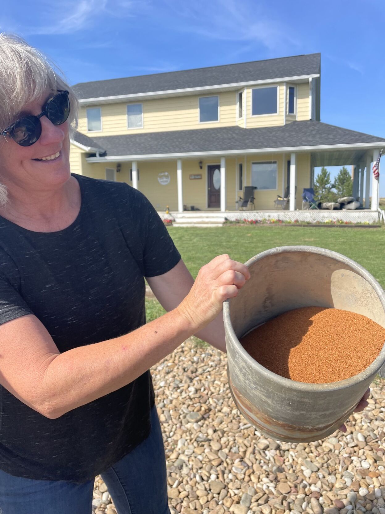 Jennifer Walker with a bucket of camelina seeds- photo by Marie Flanagan.jpg
