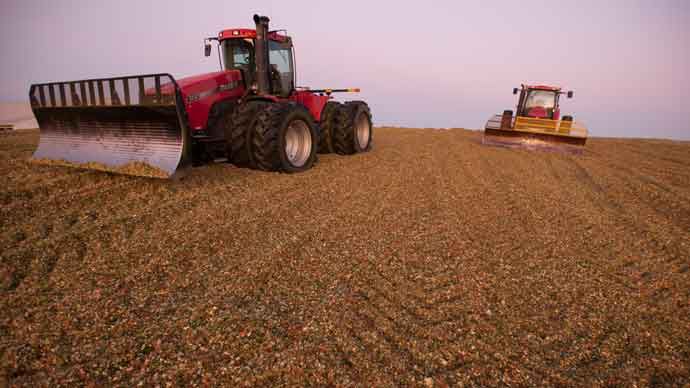 Packing tractors atop corn silage