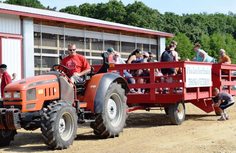 Tractor and wagon transporting farm breakfast attendees