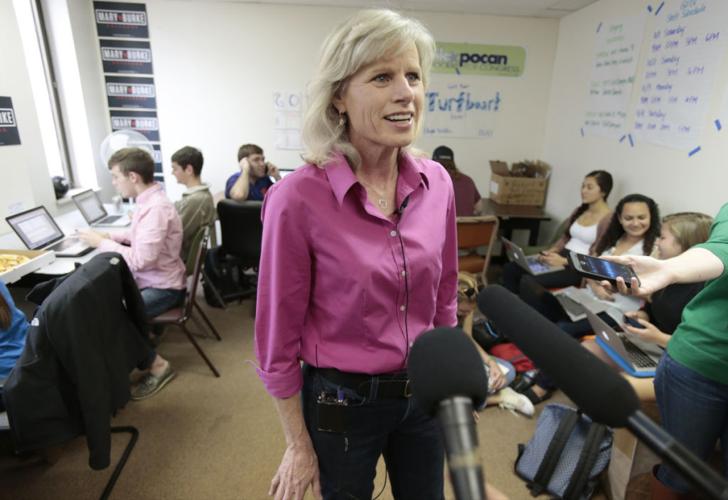 Mary Burke talks to reporters