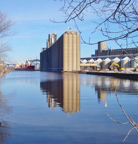 Silos reflect in water
