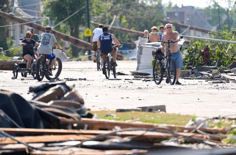 People make their way along Plank Road following severe weather, including a tornado Monday, July 27, 2026, in Menasha,
