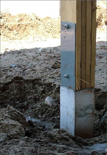 Laminated post sits on a pre-cast concrete base.