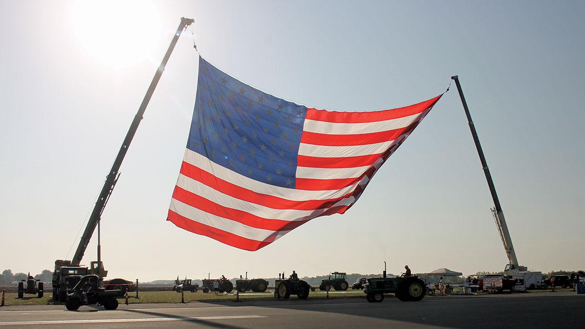 flag flies over the Half Century of Progress antique tractor show