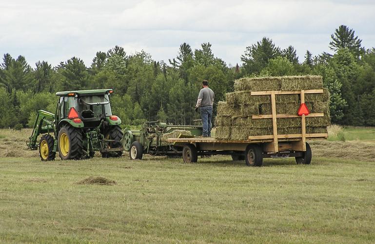 Tractor and baler in field