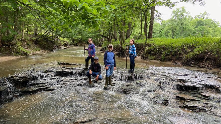 The Wright kids play in the North River