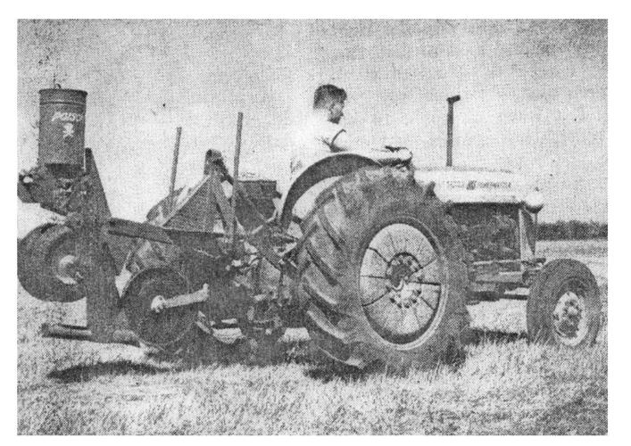 A machine to place poison in soil to kill gophers is demonstrated