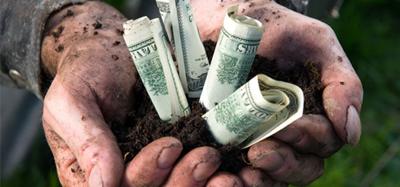 Hands with dirt and money in them