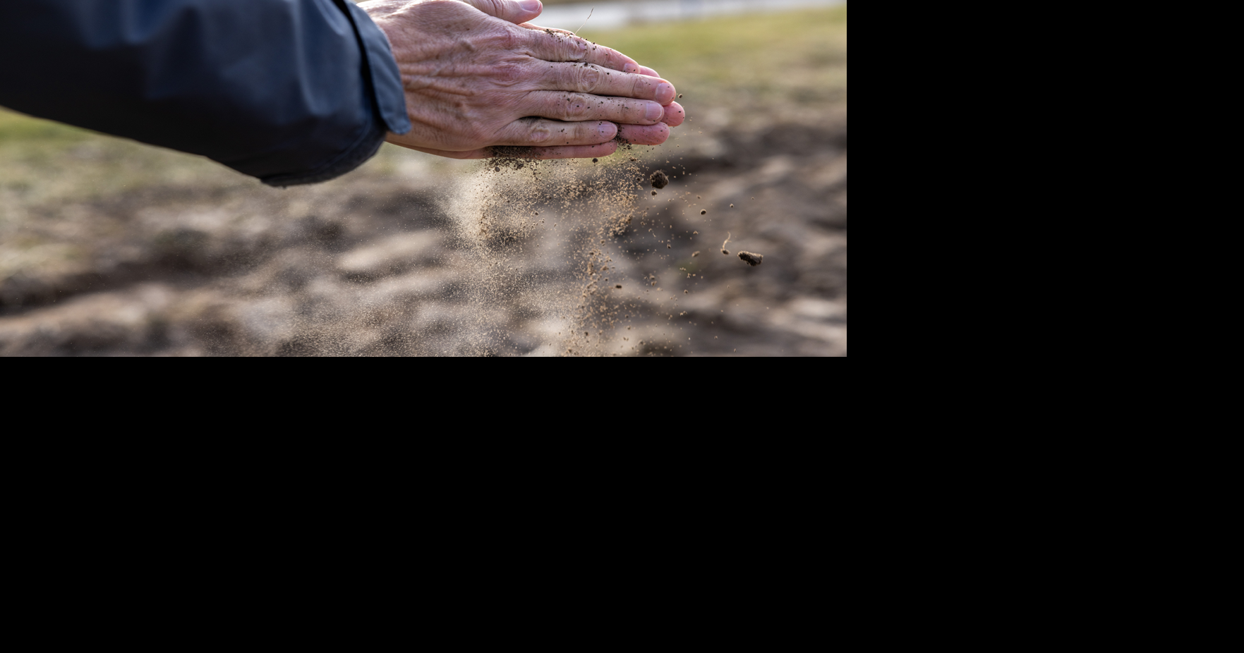 Hands holding dirt