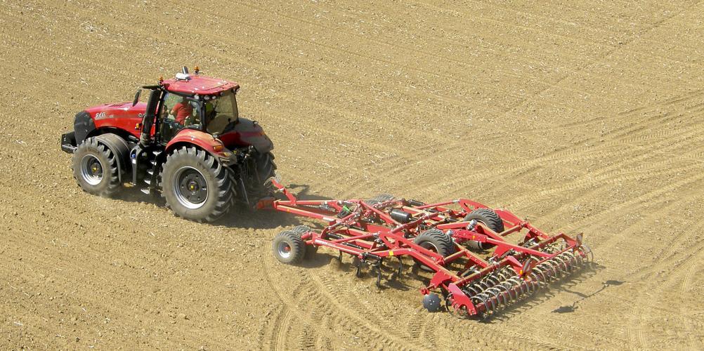 Farmer prepares field for planting