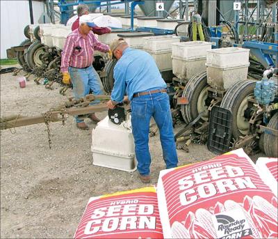 farmers loading seed corn in planter