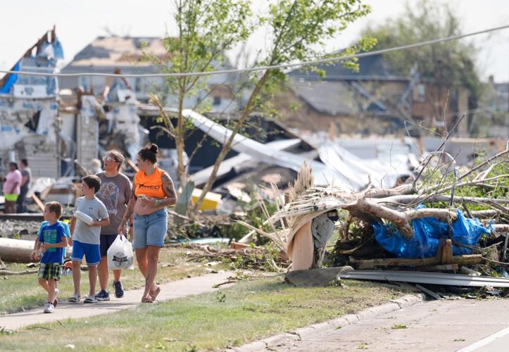 People look at vast damage following severe weather, including a tornado Monday, July 27, 2026, in Menasha, Wisconsin. Dan