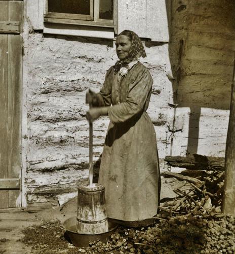 Woman churns butter