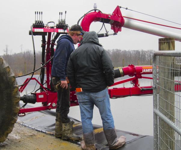 Men at manure agitator