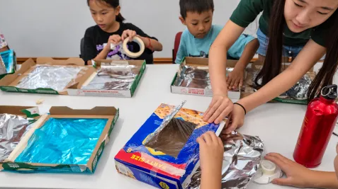 Kids building solar oven