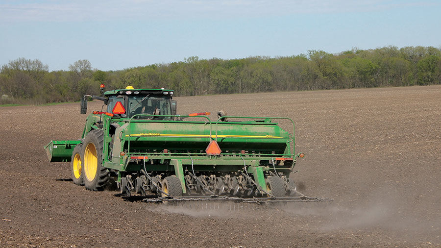 Steve Cornell steers a planter across a field in Warren County
