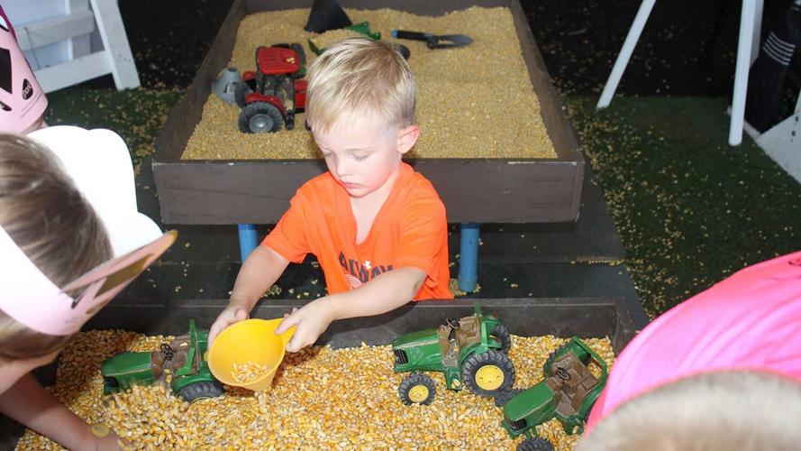 Beckam Moeller, St. Louis, enjoys the corn and farm toys